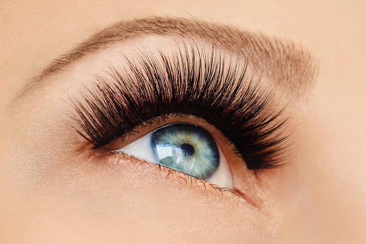 Female eye with extreme long false eyelashes